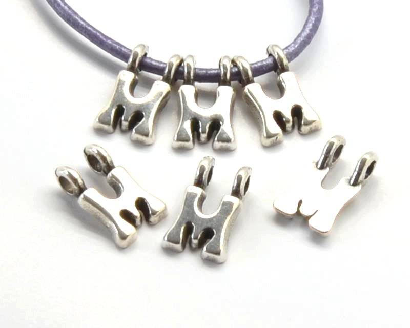 Zamak. Pendant. Letter M. Silver color. 9mm. Inn.2.2mm.