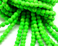 Turquoise. Dyed. Round. 6mm. Fluoresent green. Inn.1mm.approx.